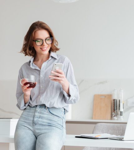 Portrait of a happy attractive woman using mobile phone