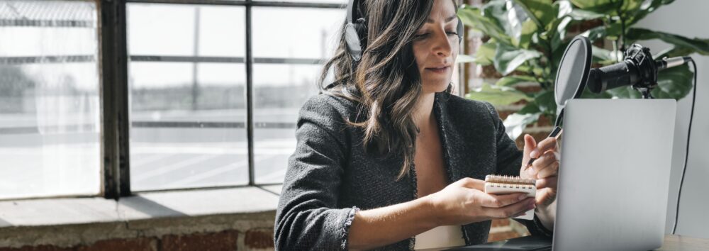 Female radio host broadcasting online in a studio